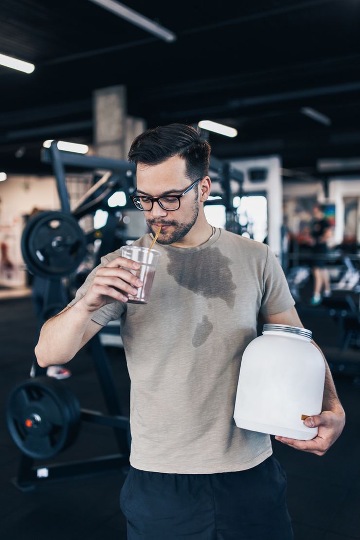 Young man drinking protein shake after gym workout