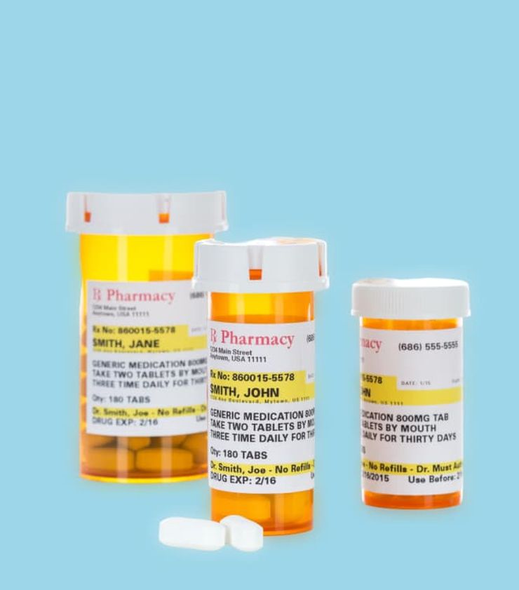 Various prescription medication bottles and pills arranged on a table