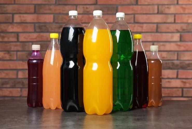 Assortment of colorful sugary soda bottles representing fructose consumption