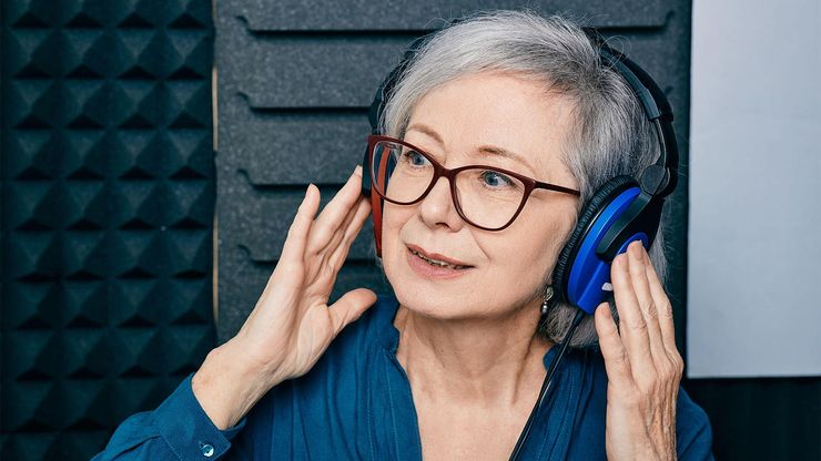 Woman receiving a hearing test in a sound booth with headphones