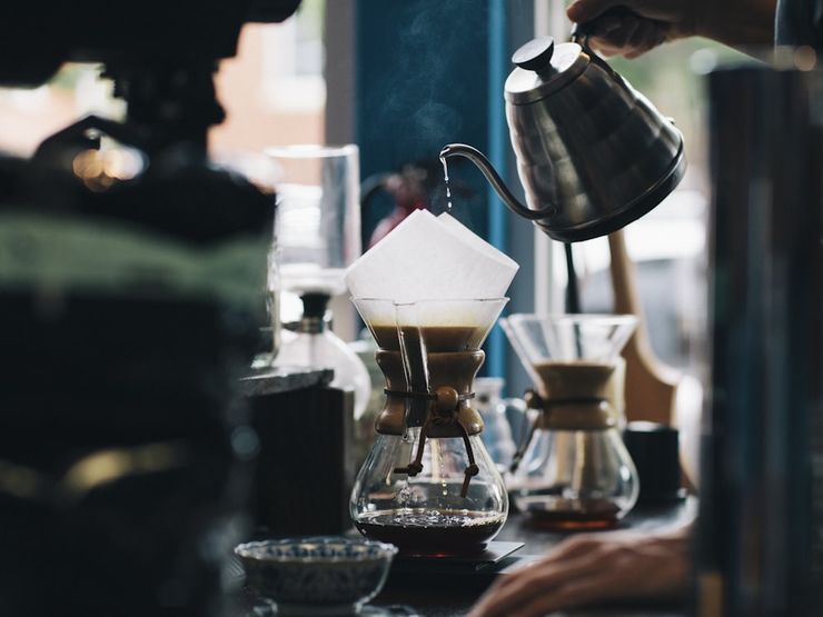 Freshly brewed black coffee being made with a pour-over dripper, the kind of plain coffee linked to lower uric acid in gout studies