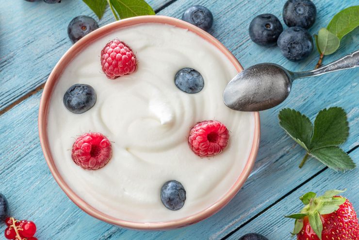 Plain low-fat yogurt topped with fresh berries in a bowl