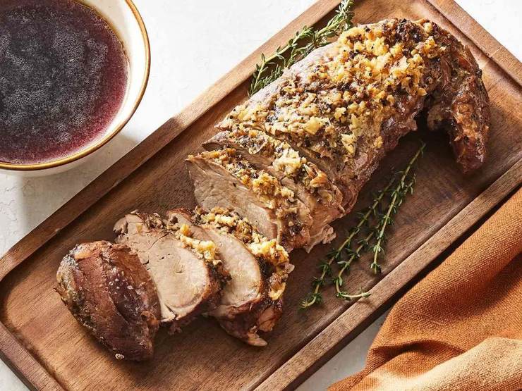 Sliced roasted pork tenderloin, a moderate-purine cut best kept to a sensible portion